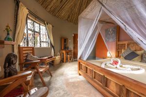 a bedroom with a bed with a mosquito net at Africa Safari Arusha in Arusha