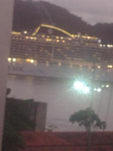 a cruise ship at night with a light at Sunset in Santos