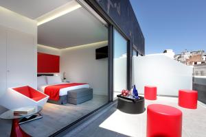 a hotel room with a bed and a balcony at Eurostars Central in Madrid