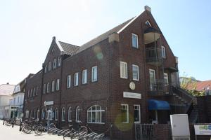 a brick building with bikes parked outside of it at Fishermans in Borkum
