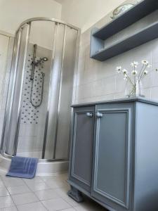 a bathroom with a shower and a blue cabinet at Villa Simonetta in Castellina Marittima +62 photos