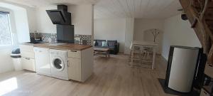 a kitchen with a washer and dryer in a room at Le Temps Suspendu in Saint-Pierreville +14 photos