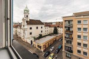 a view from a window of a city street with a church at Apartment FRIENDs Bratislava in Bratislava