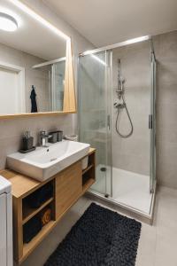 a bathroom with a sink and a shower at Apartment FRIENDs Bratislava DOWNTOWN !!! in Bratislava