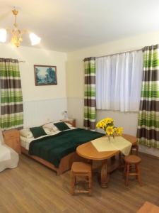 a bedroom with a bed and a table in it at Dom Wczasowy Jędrek pokoje in Niechorze