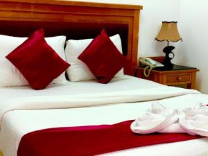 Ένα ή περισσότερα κρεβάτια σε δωμάτιο στο Savoy Inn Hotel Apartments