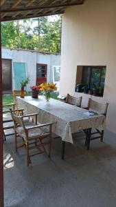 a large white table with chairs and flowers on it at sobe MAŠA in Subotica