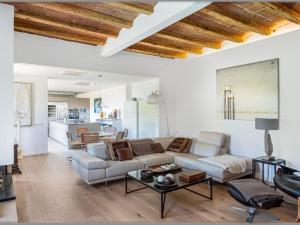 a living room with a couch and a table at Chalet sea and mountain views - 5 min from Golf in Sant Vicenç de Montalt