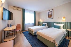 Posteľ alebo postele v izbe v ubytovaní Hotel H12****