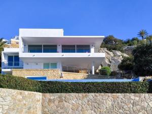 a white house on top of a stone wall at REf 6 VILLA TARA in Zahara de los Atunes