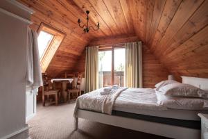 a bedroom with a bed in a wooden house at Willa Apart in Zakopane