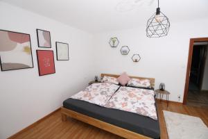 a bedroom with a bed and pictures on the wall at Moderne, herzliche und große Ferienwohnung mitten im Naturpark in Grebenhain