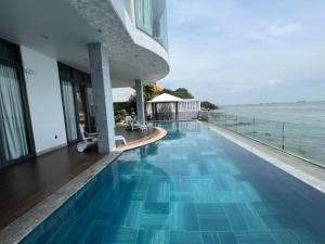 a swimming pool with a view of the ocean at Nancy Tran Grand Strip Vung Tau Villa 7 in Vung Tau