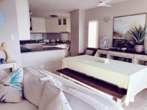 a living room with a bed and a kitchen at 15 Dorado Bay in Tinley Manor