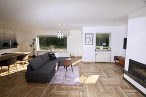 a living room with a couch and a dining room at Moderne, herzliche und große Ferienwohnung mitten im Naturpark in Grebenhain