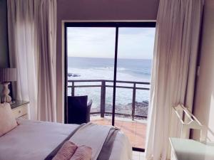 a bedroom with a bed and a view of the ocean at 15 Dorado Bay in Tinley Manor