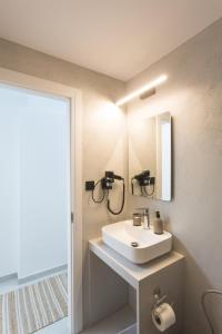 a bathroom with a white sink and a mirror at K studios in Kalamata