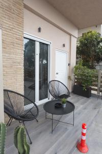 a patio with two chairs and a table and a patio at K studios in Kalamata