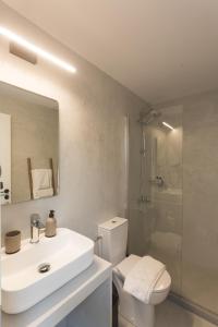 a bathroom with a sink and a toilet and a shower at K studios in Kalamata