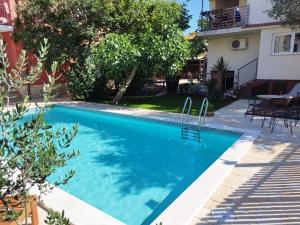 a swimming pool in the backyard of a house at Apartment Kućica in Zadar
