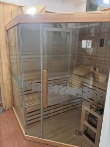 a glass display case with wood inside of it at Domačija Paternoster in Litija