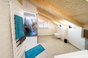 a bathroom with a sink and a toilet in a room at Ferienwohnungen Zum Bachl - Karwendelblick in Krün +4 photos