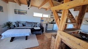 a living room with a couch and a table at Wigierska Buchta (DOMKI) in Rosochaty Róg