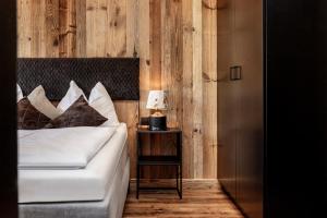a bedroom with a bed and a table with a lamp at Landhaus Rustika in Wagrain
