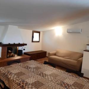 ein Wohnzimmer mit einem Sofa und einem Bett in der Unterkunft La Rosa dei venti in Calatafimi