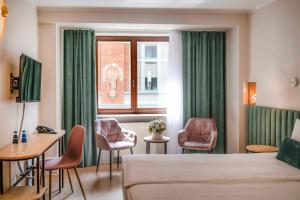 Televízia a/alebo spoločenská miestnosť v ubytovaní Hotel H12****