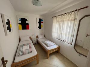 a small room with two beds and a mirror at Villa Ava in Kotor +20 photos