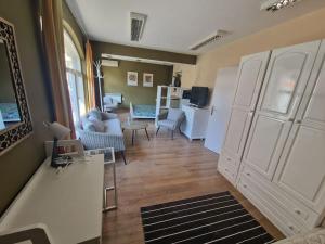a living room with a couch and a living room with at La Maison Ruse Apartments in Ruse