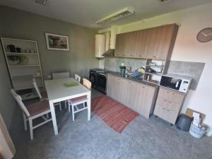 a kitchen with a table and a table and chairs at La Maison Ruse Apartments in Ruse