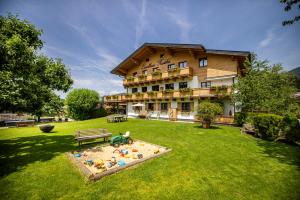 a large building with a sandbox in the yard at Landhaus Rustika in Wagrain