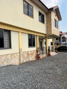 a house with a gravel driveway in front of it at SUCCESS ROSE - East Legon, Adjiringanor in Accra