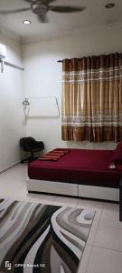 a bed in a room with a curtain and a bed sidx sidx sidx at RW segamat homestay in Segamat