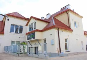 a white house with a red roof at APART MAZURY Apartamenty na Mazurach in Orzysz