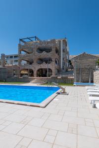 a swimming pool in front of a building at Pool apartment Ena in Pag