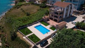 an aerial view of a house with a swimming pool at Pool and Beachfront Apartment Ena - Perfect Family Escape in Pag +34 photos