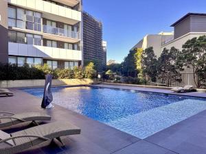 a swimming pool in the middle of a building at Cosy One Bedroom Apartment in Castle Hill, NSW in Castle Hill