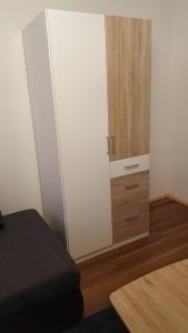 a bedroom with a white closet and a wooden cabinet at Bertel 1 in Wernigerode