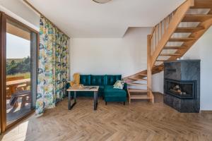 a living room with a couch and a fireplace at Domki Pieniny in Grywałd