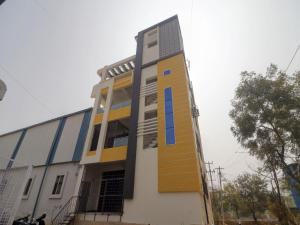 a building with a staircase on the side of it at OYO Home RBS Homes in Maula Ali