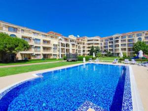 a large swimming pool in front of a large apartment building at Apartment Monica in Sveti Vlas