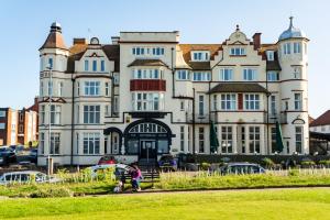 a large building with people walking in front of it at Cliftonville Hotel in Cromer