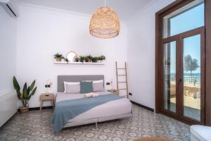 a bedroom with a bed and a view of the ocean at Villa Molinar in Palma de Mallorca +16 photos
