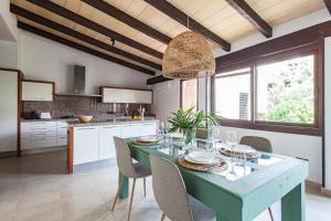 a kitchen with a blue table and chairs in it at Villa Molinar in Palma de Mallorca