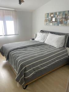 a bedroom with a large bed in a white room at Modern Croatian House in Pula