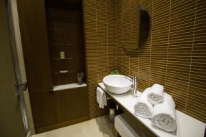 a bathroom with a sink and a mirror at Apartamentos Turísticos Pacios in Santiago de Compostela +37 photos