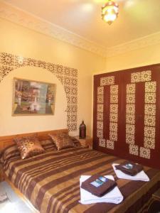 a bedroom with a large bed with towels on it at ESCAPADE Assilah in Asilah